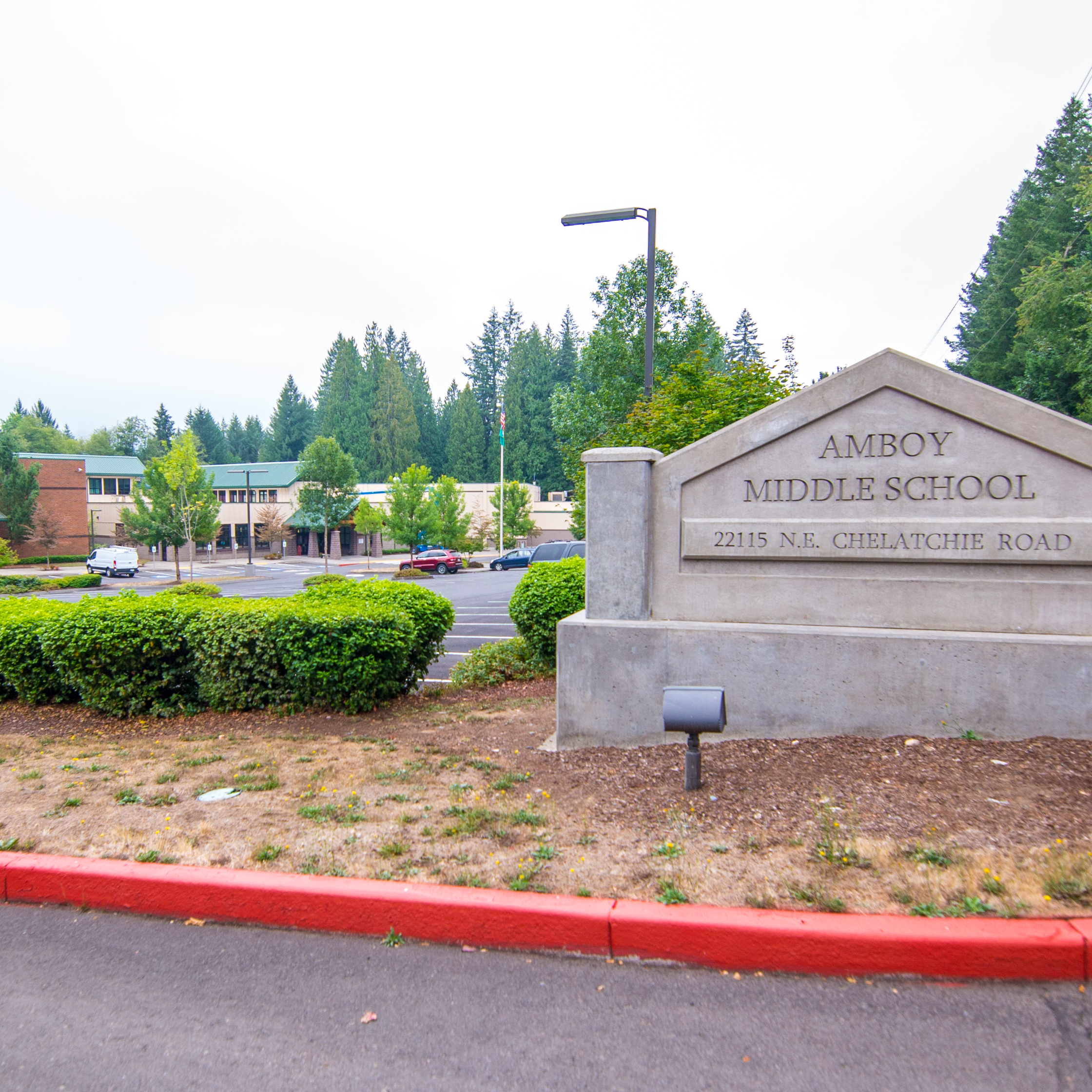 Exterior shot of Amboy Middle School, with school sign in foreground