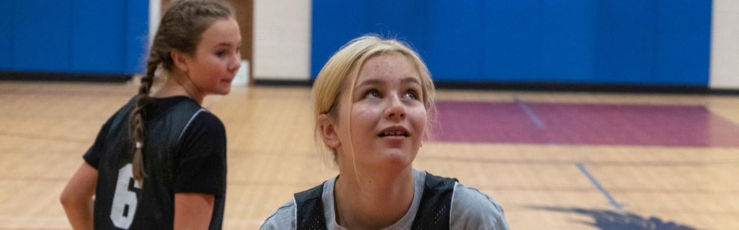 two girls playing basketball