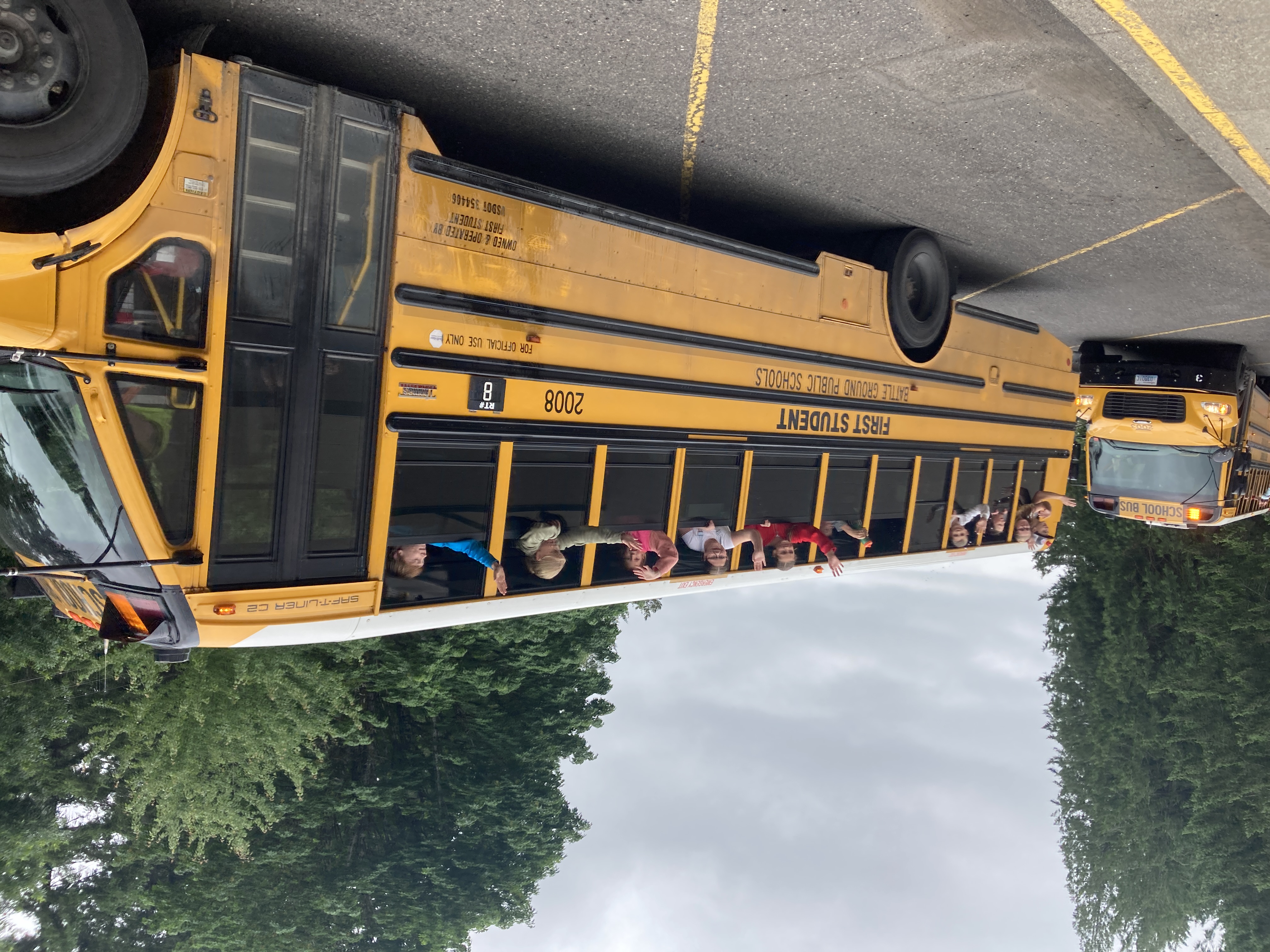 kids waving from school bus