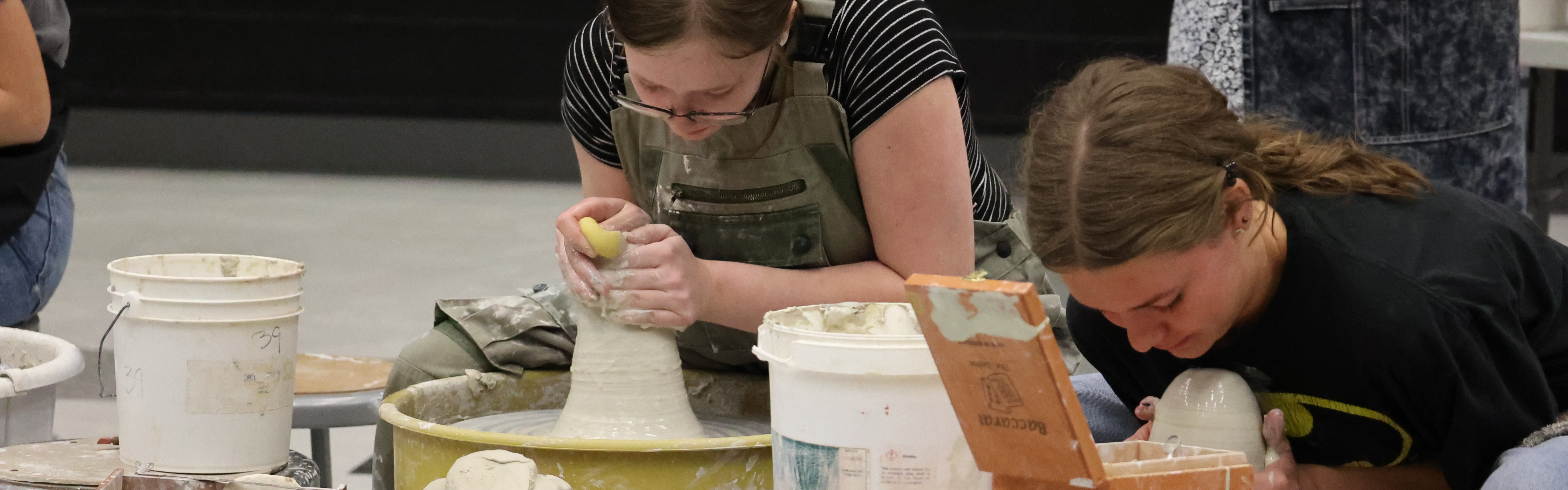 Students work with clay at ceramics competition