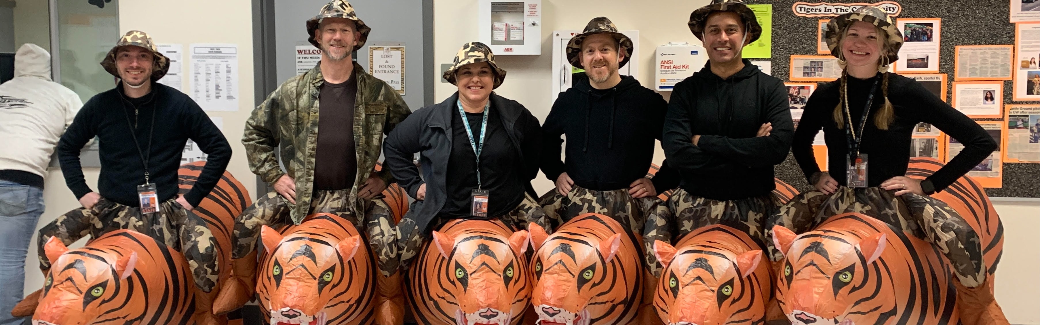 teachers standing in a line with inflatable tiger costumes