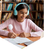 Young girl wears headphones while writing in a notebook