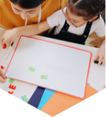 two young children work on a puzzle