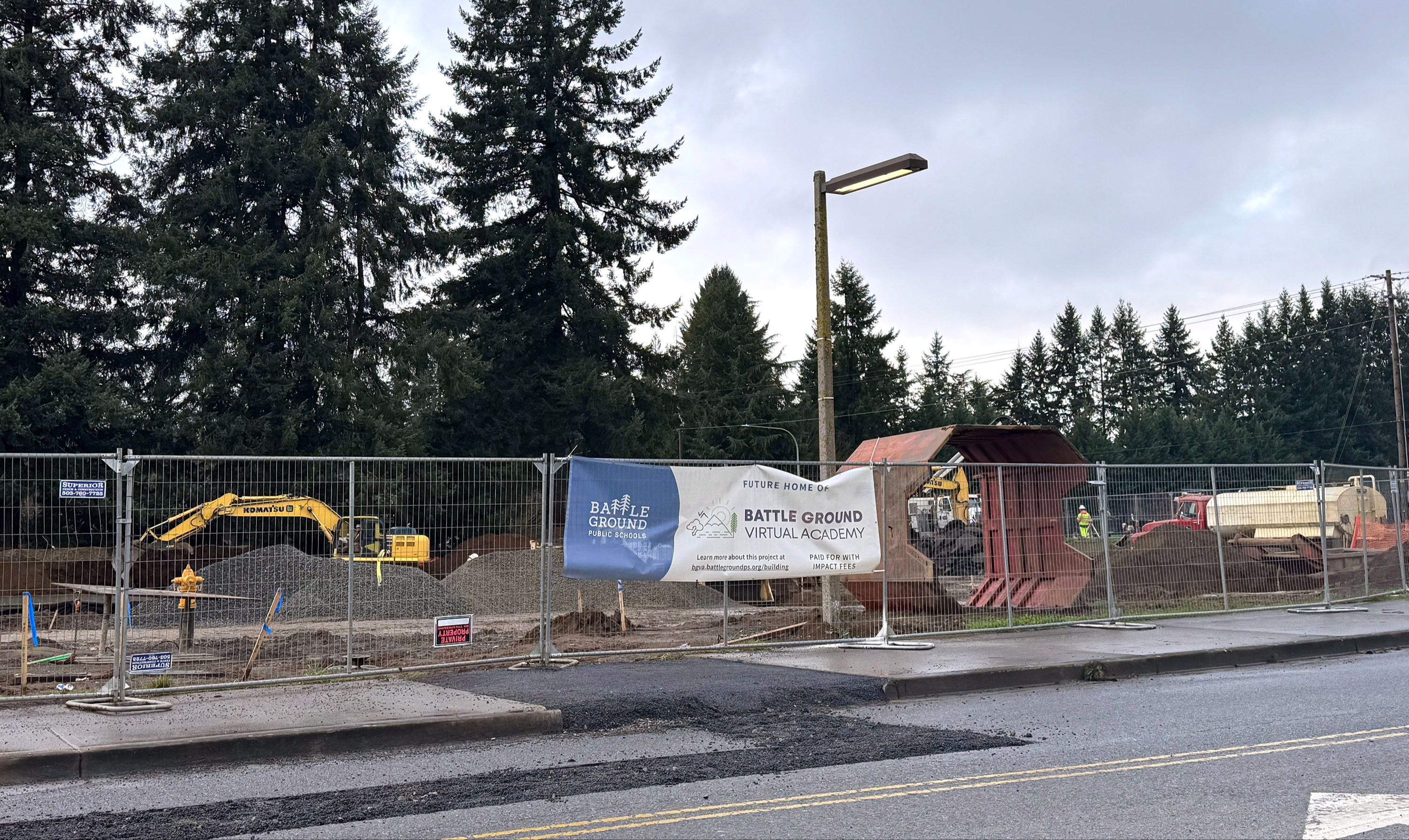 Heavy equipment prepares the footings for the modulars.