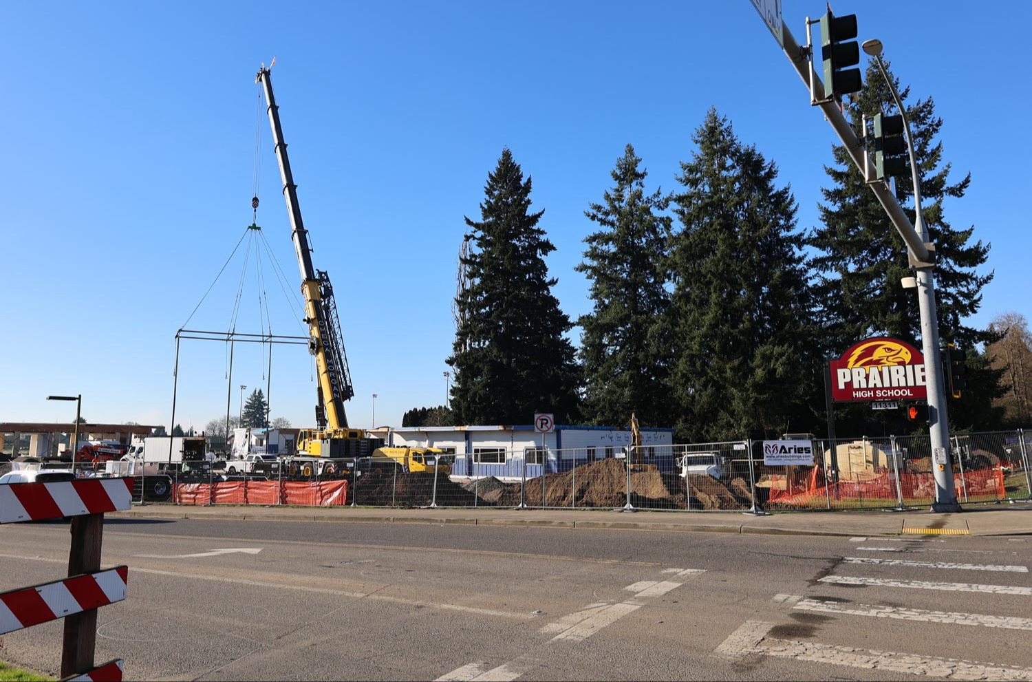 A large crane begins putting the units together in January 2026
