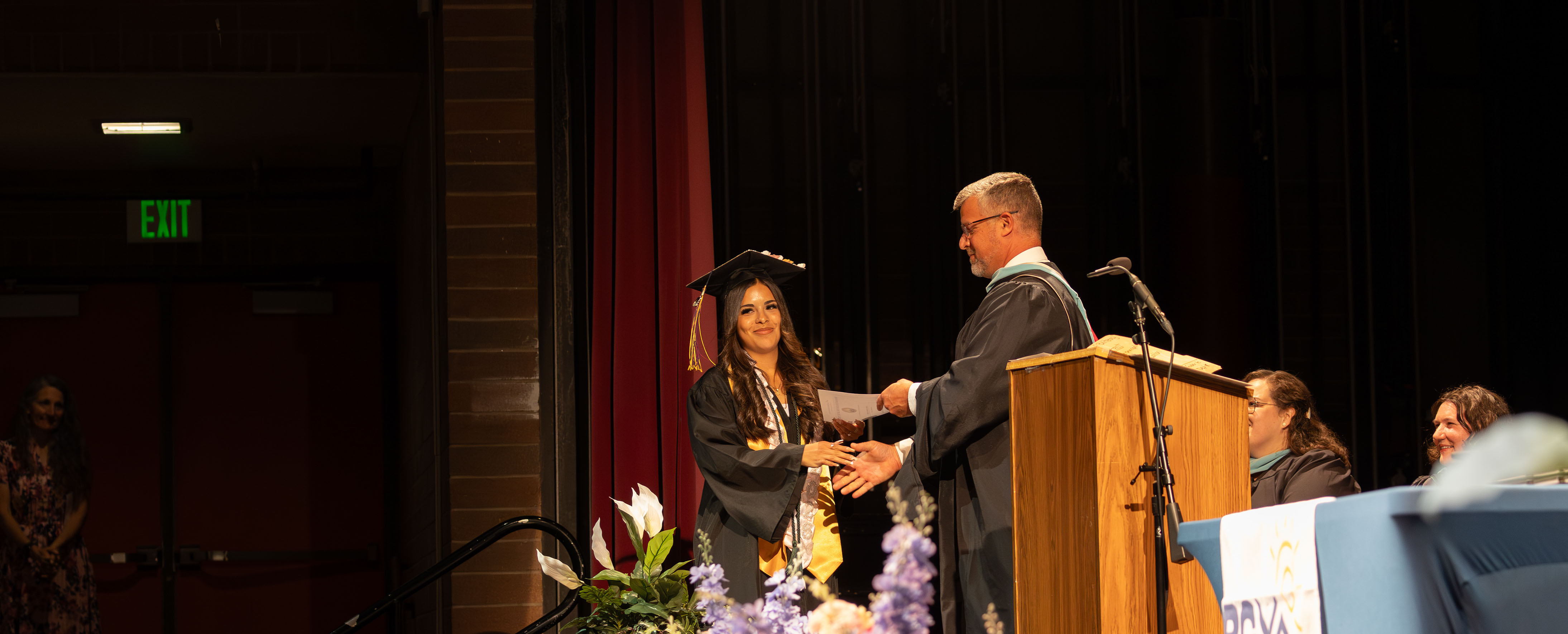 a student accepting the diploma on stage