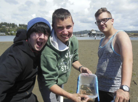 three students smiling