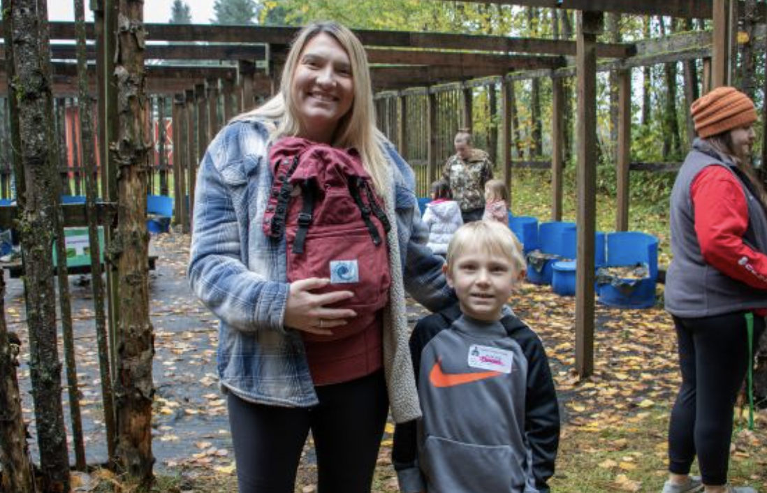 mom and kid on the pkayground posing for a picture