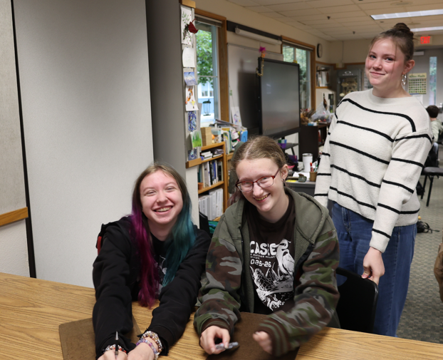 Students smile at the camera for a photo