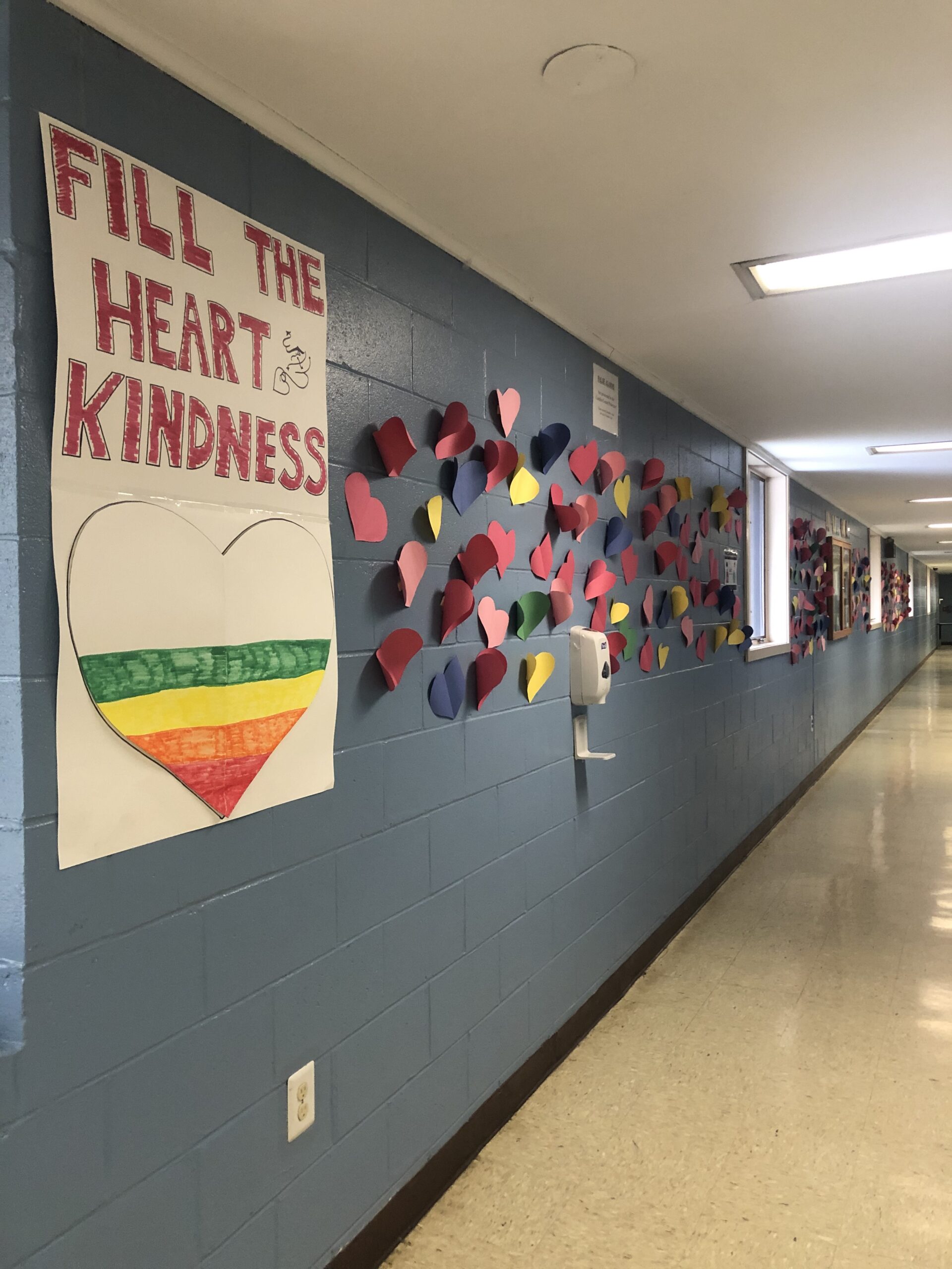 A hallway in a school with posters on the wall