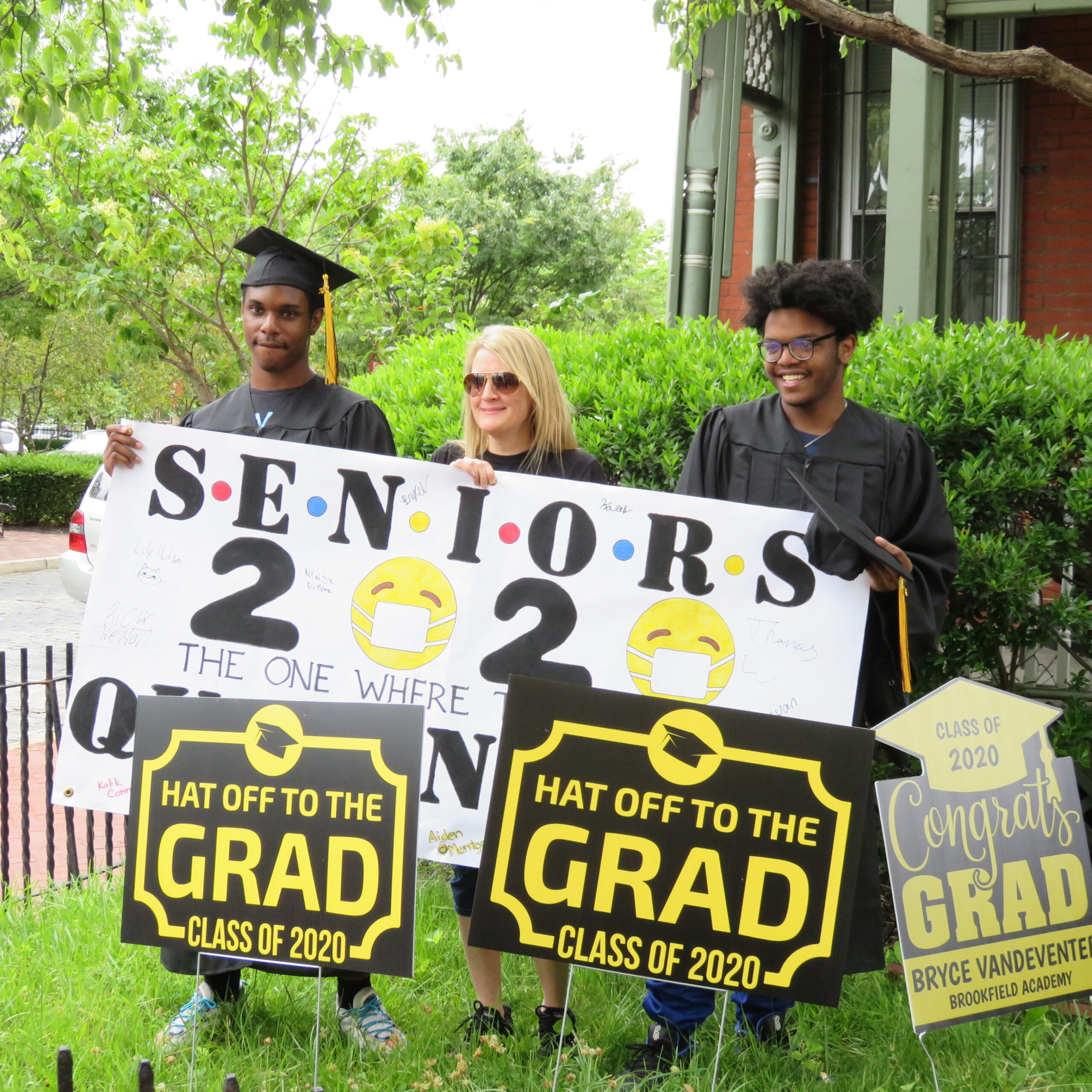 A group of people holding up signs in front of a building