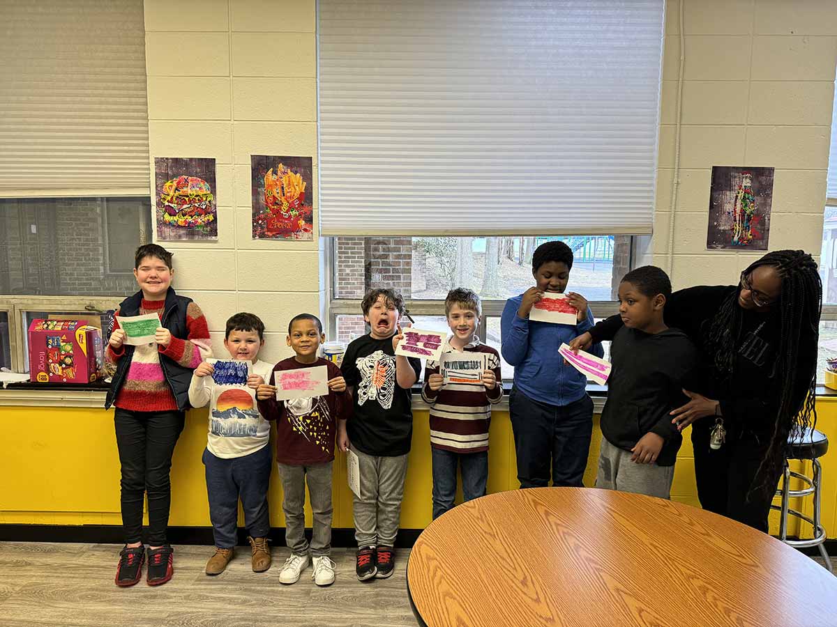 Students showing their art work