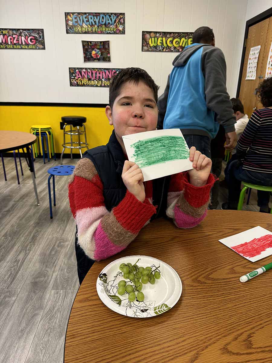 Boy Student showing his art work