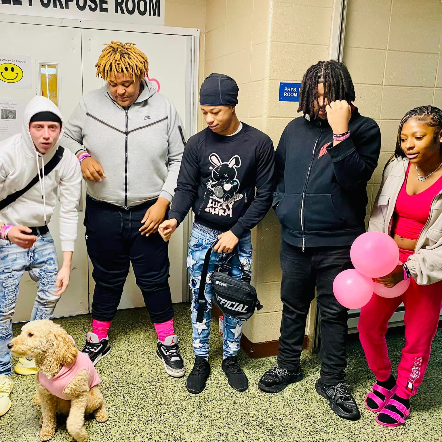 Group pictures of students with one of our therapy dogs