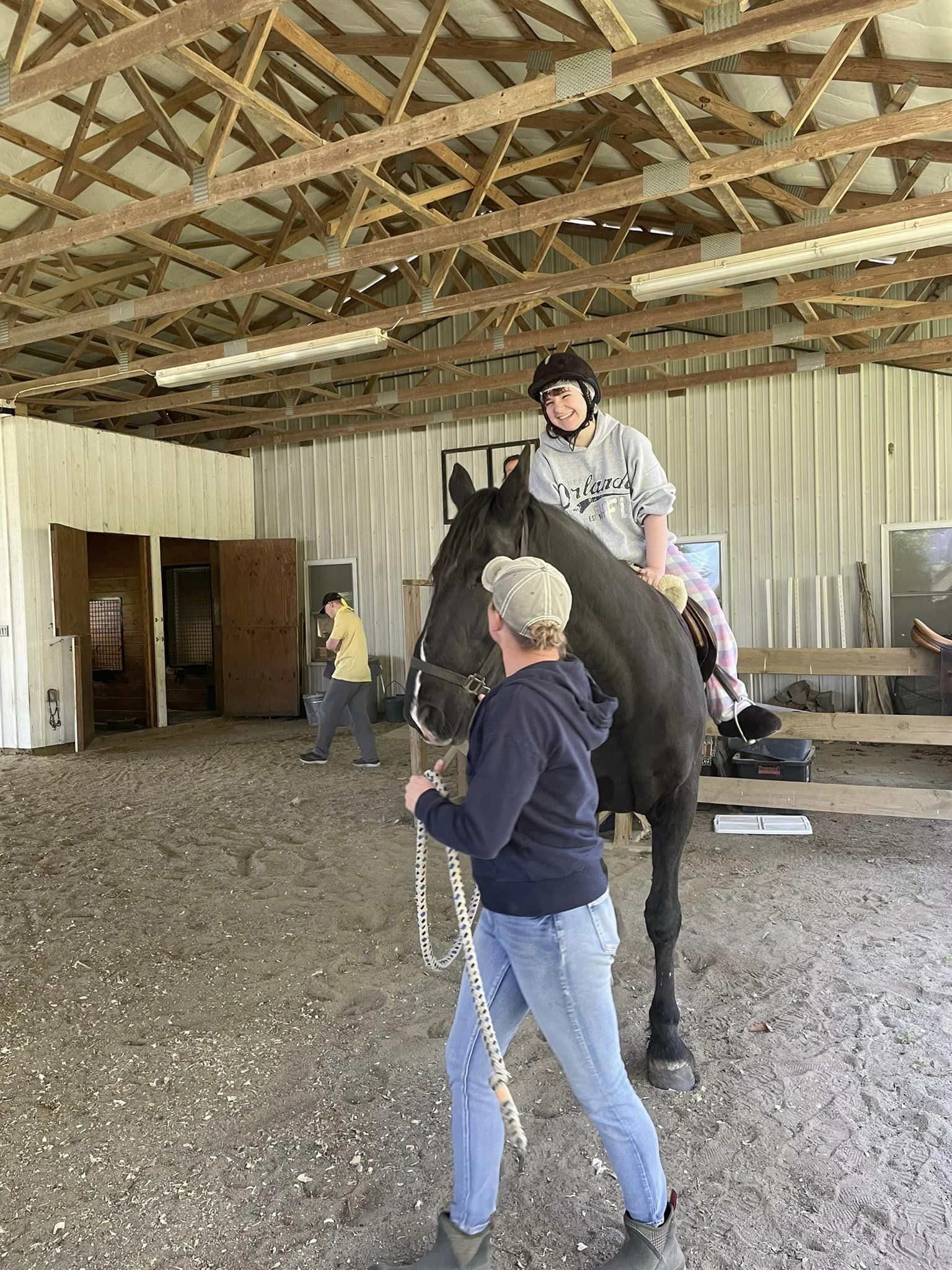 student riding horse