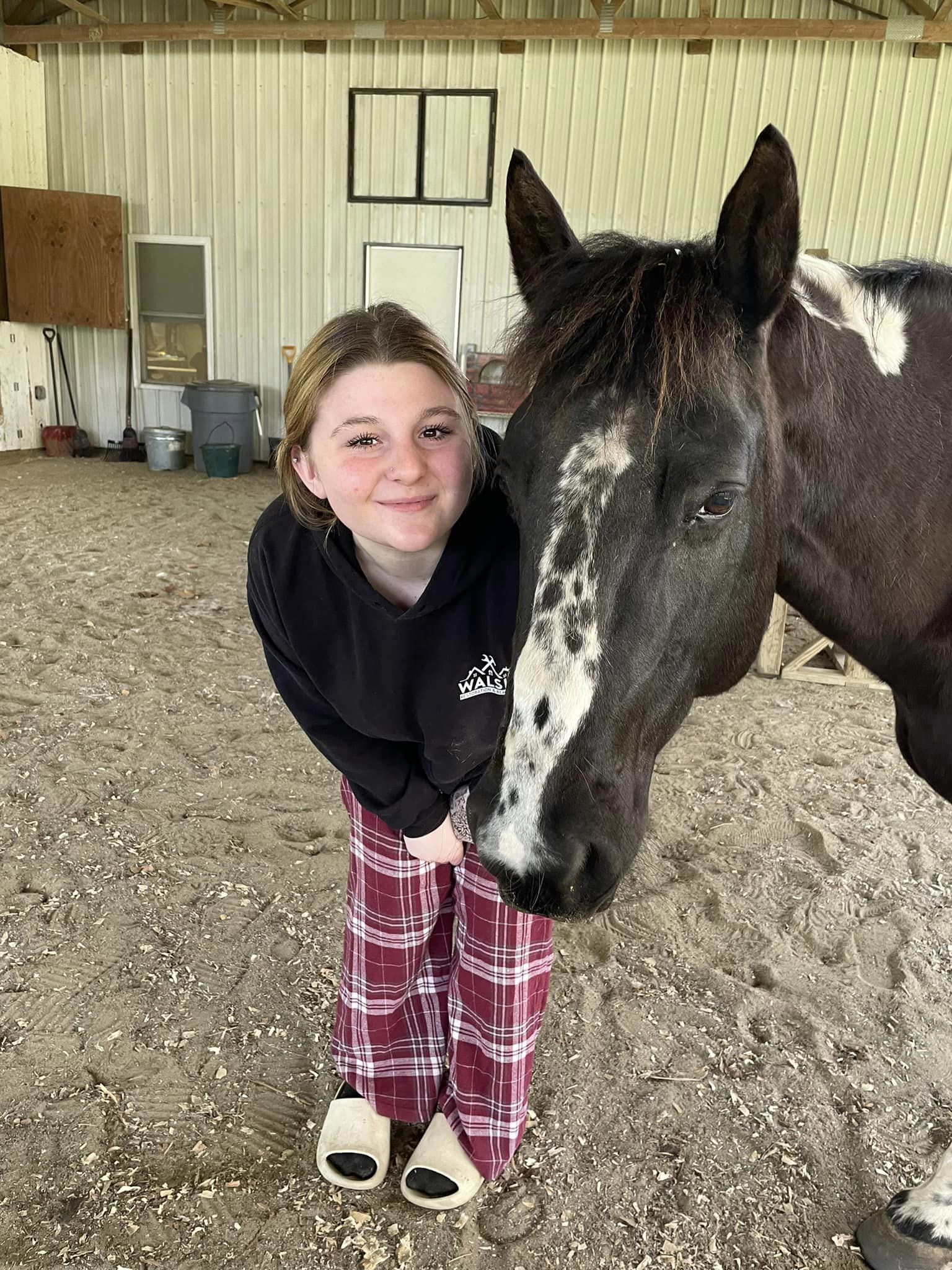 student posing with horse