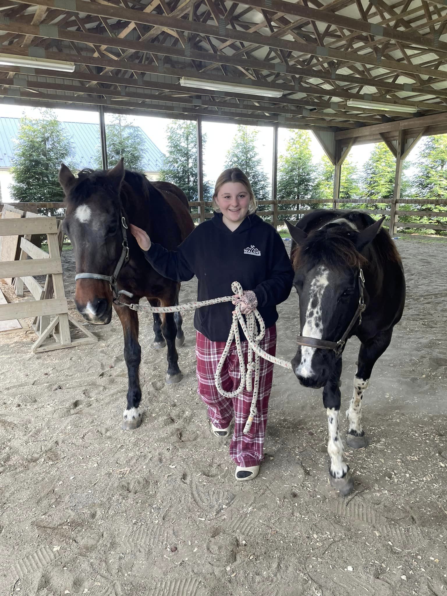 student leading horses
