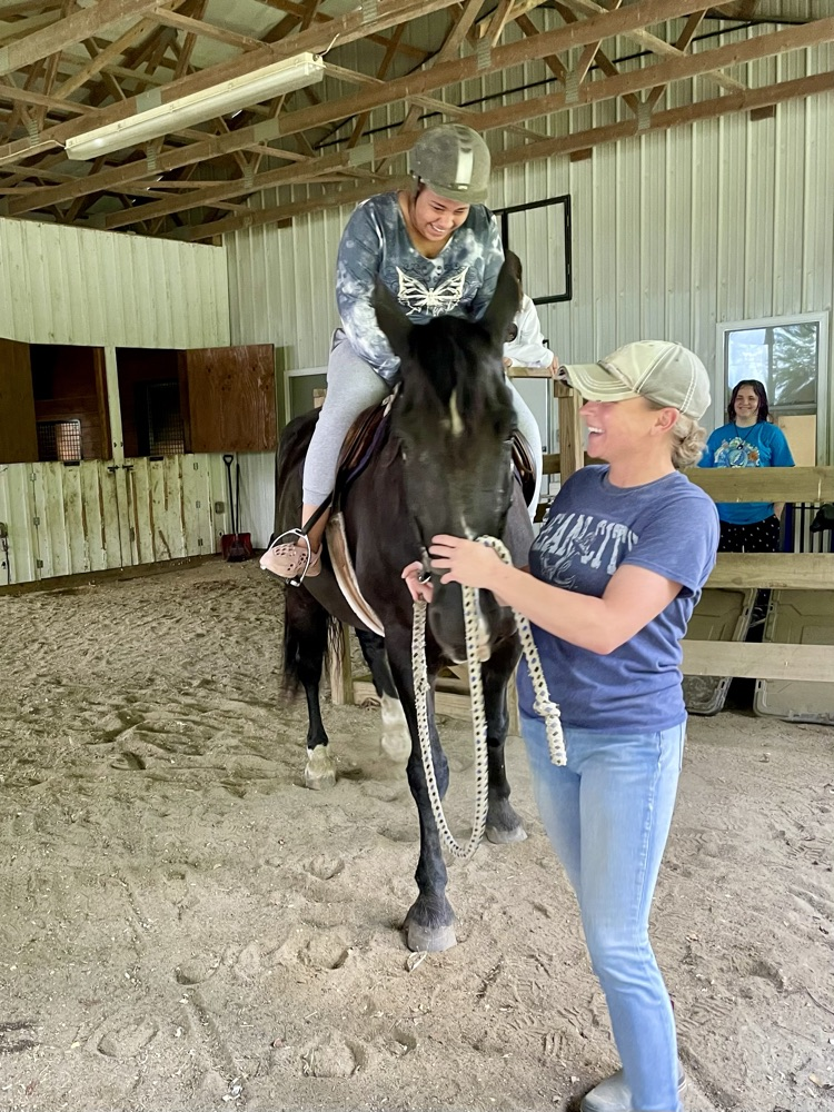 Student preparing for a horseback ride
