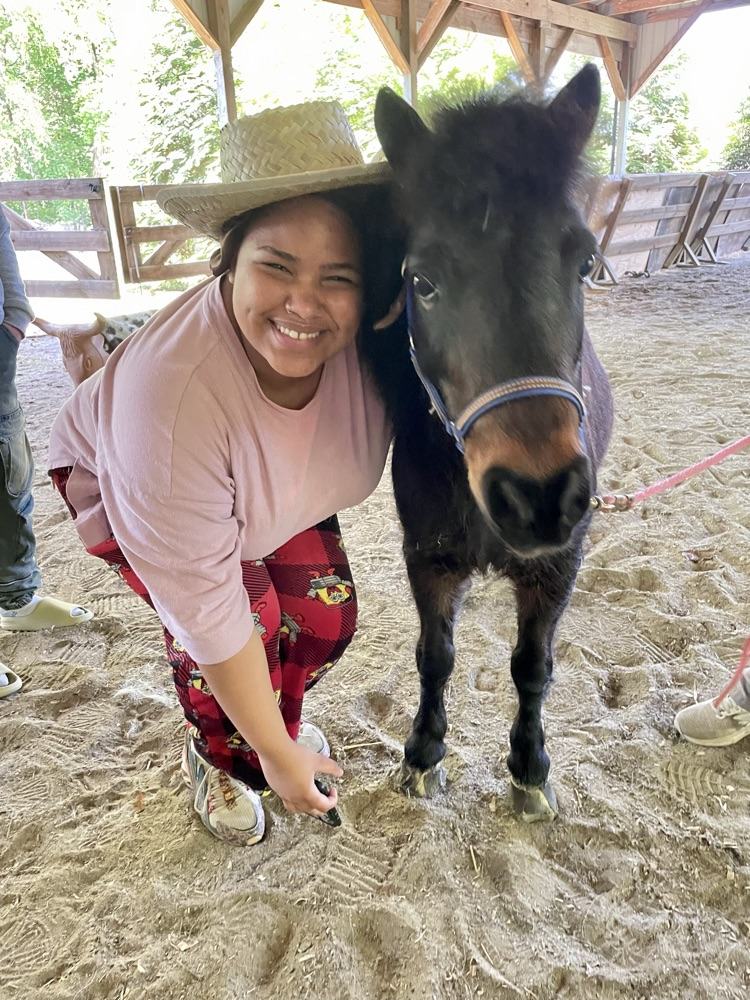 student posing with horse