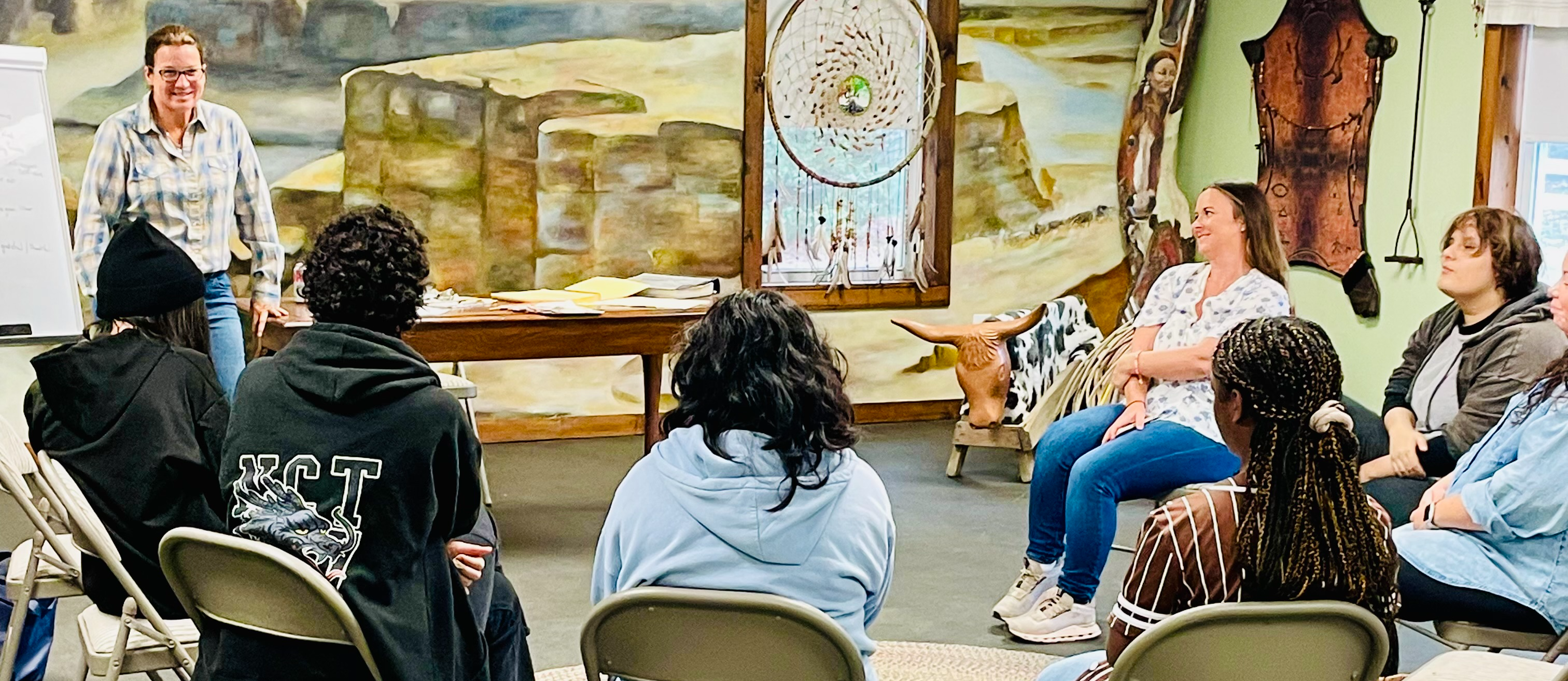 Horse therapy lesson with students sitting in a circle