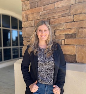 Assistant principal Mrs. Wingfield standing in front of the school 