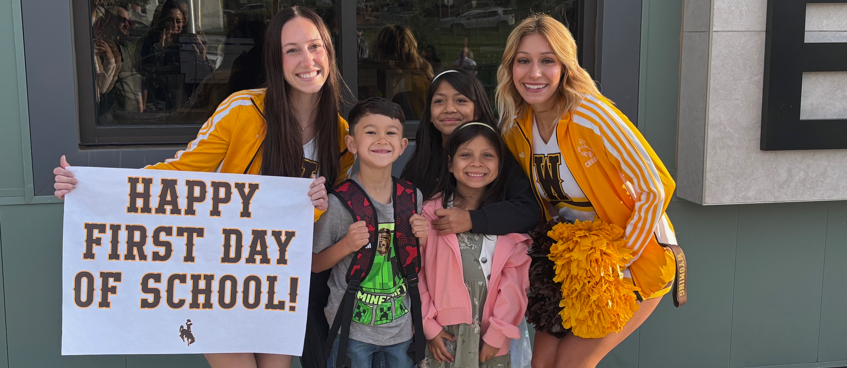 Slade students posing with UW athletes on the first day of school'