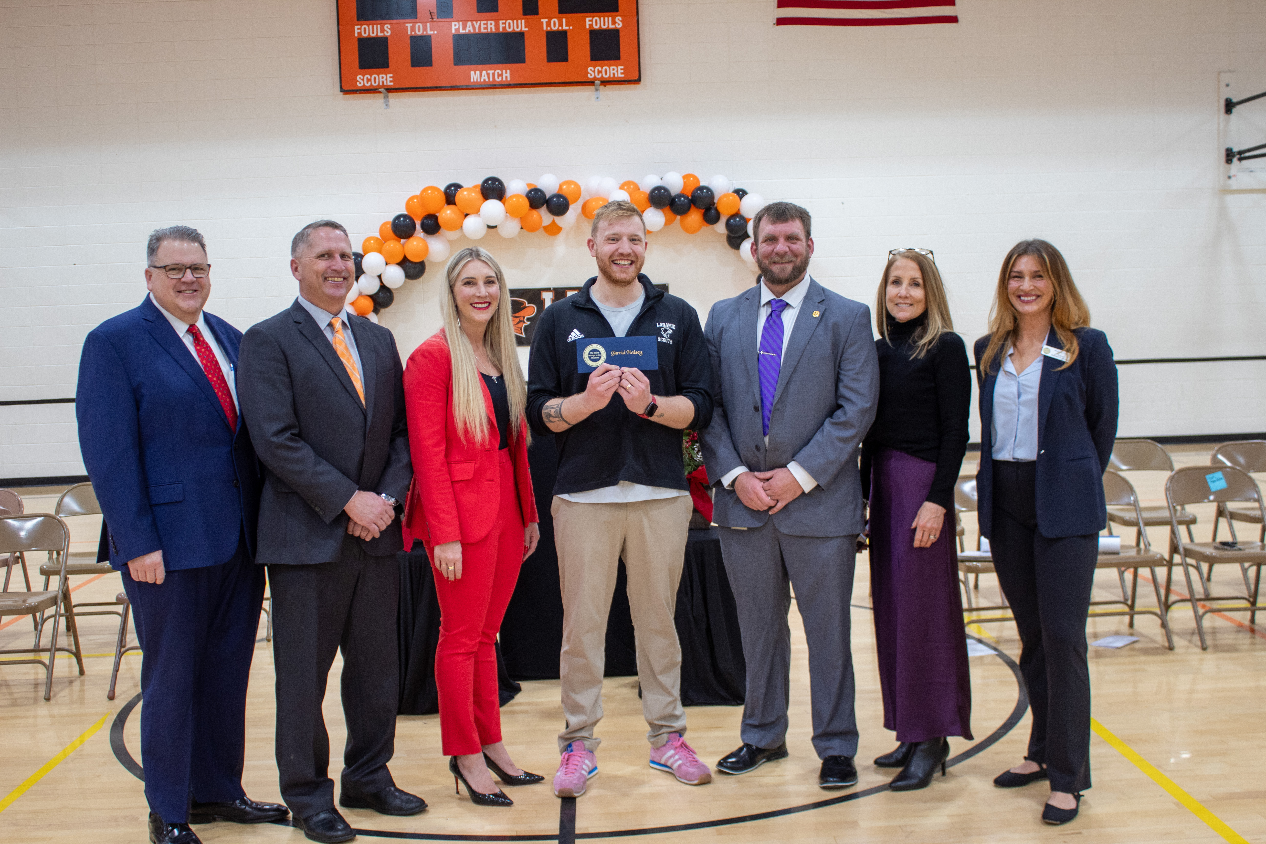 Men and women in a line posing with an award