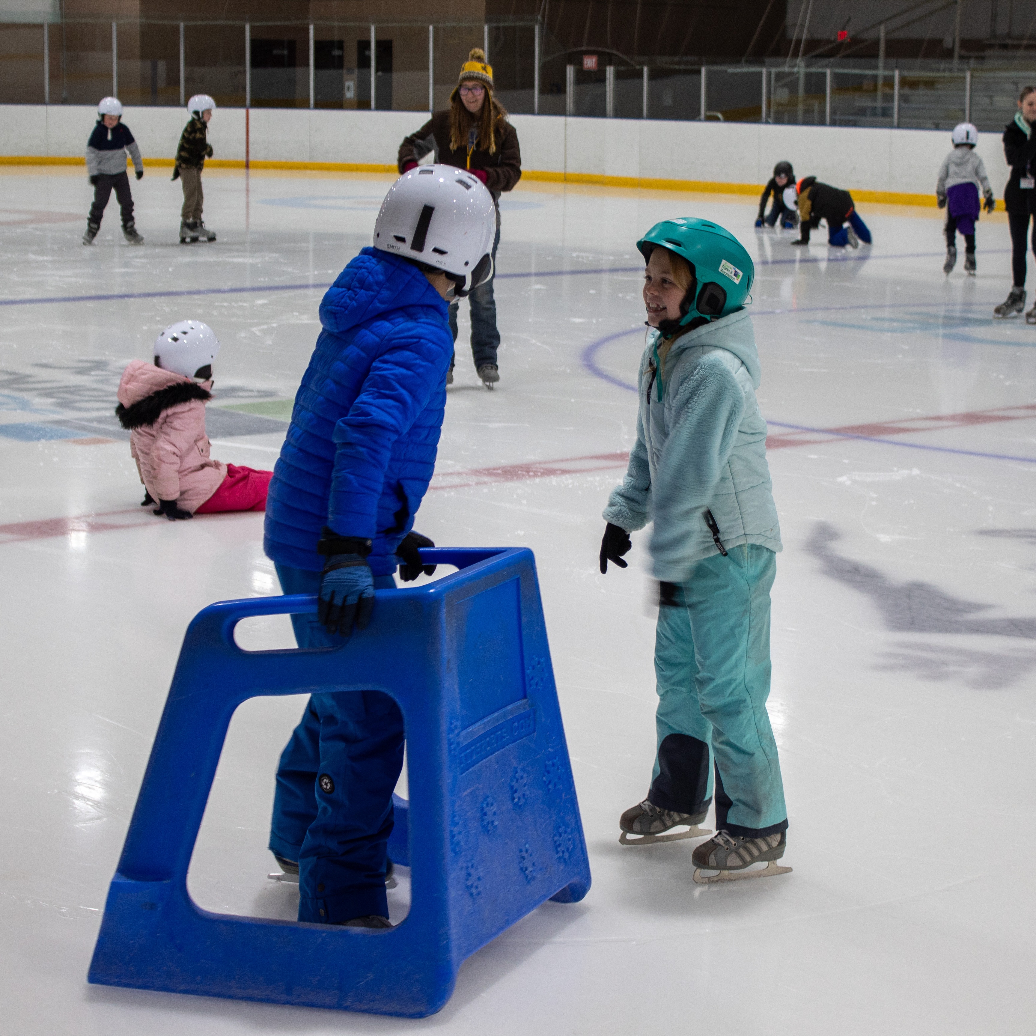 Two young children ice skating together