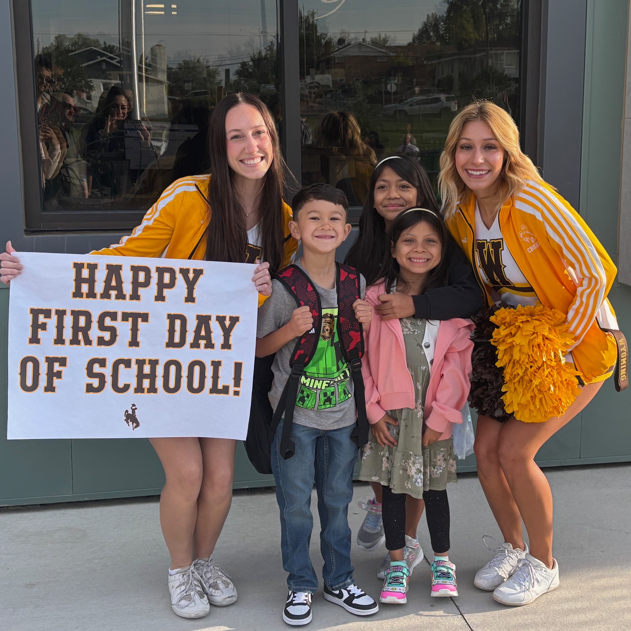Elemantary students posing with cheerleaders