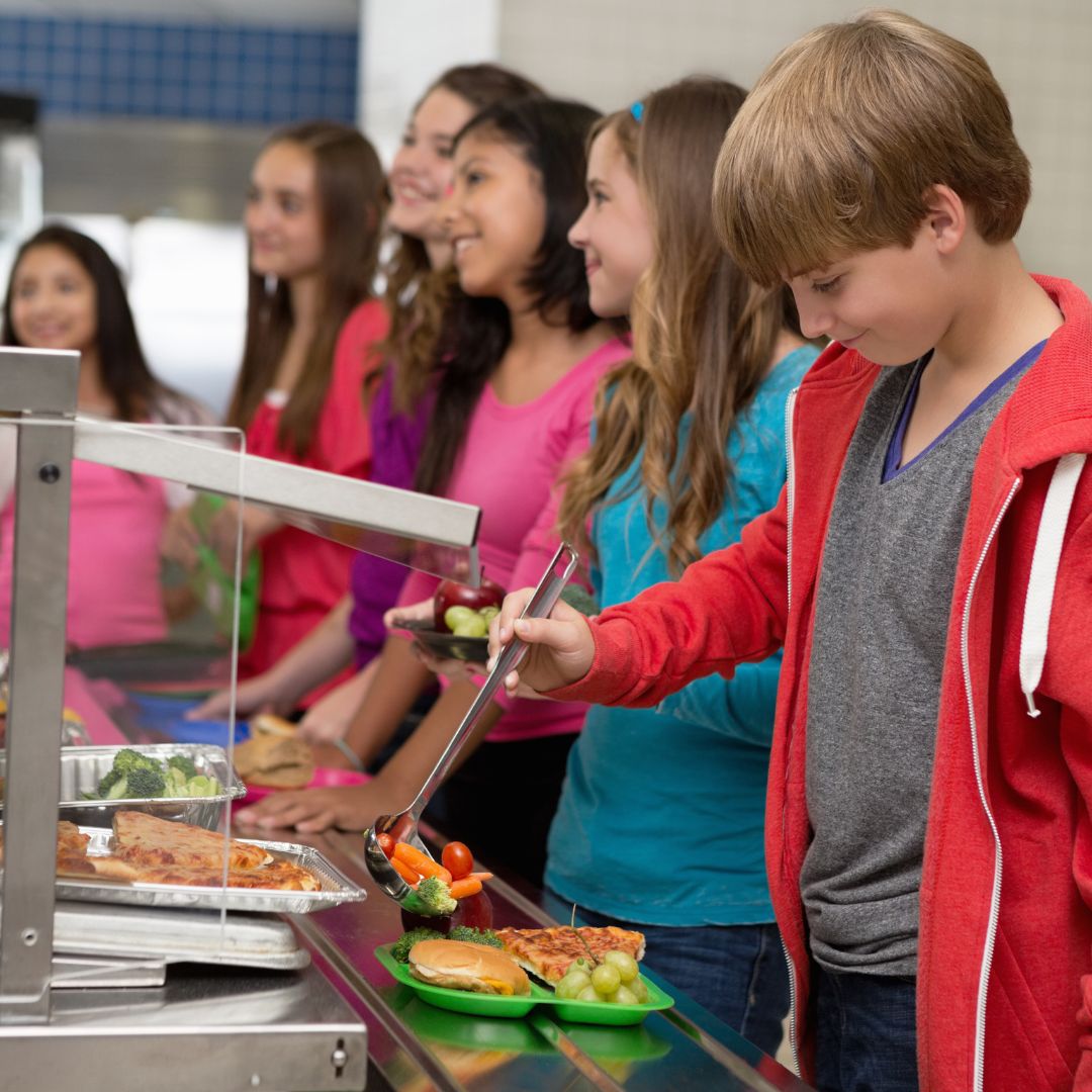 Students in lunch line dishing up food