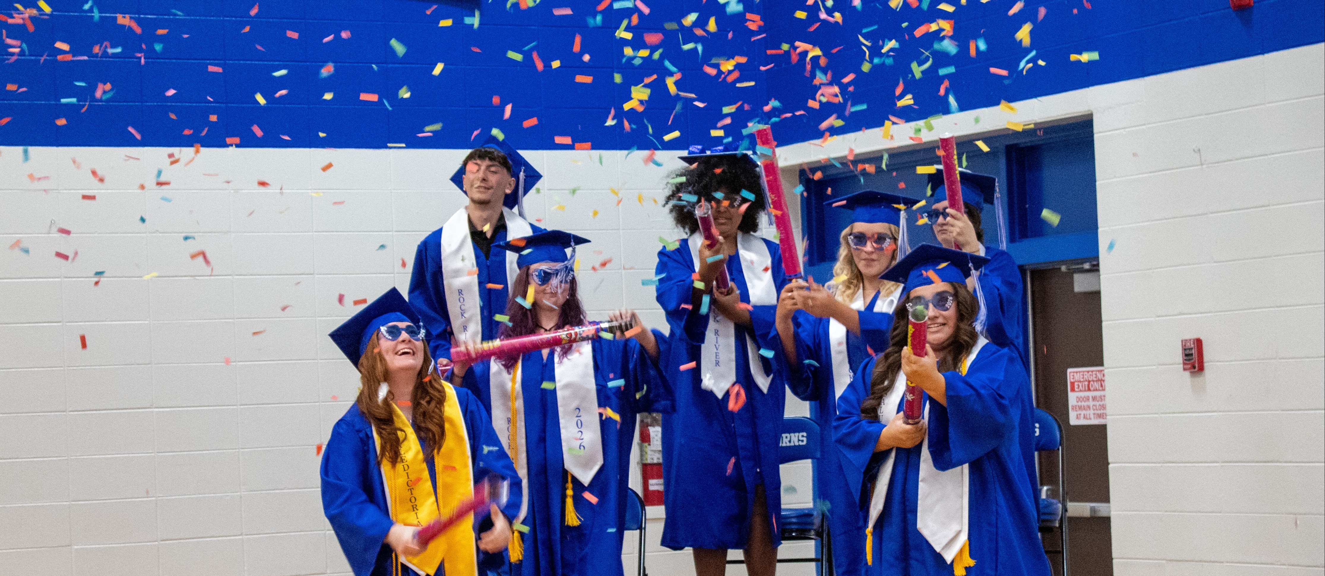 Students shooting of confetti canons as they graduate