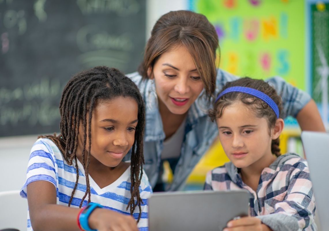 Teacher looking at students ipad