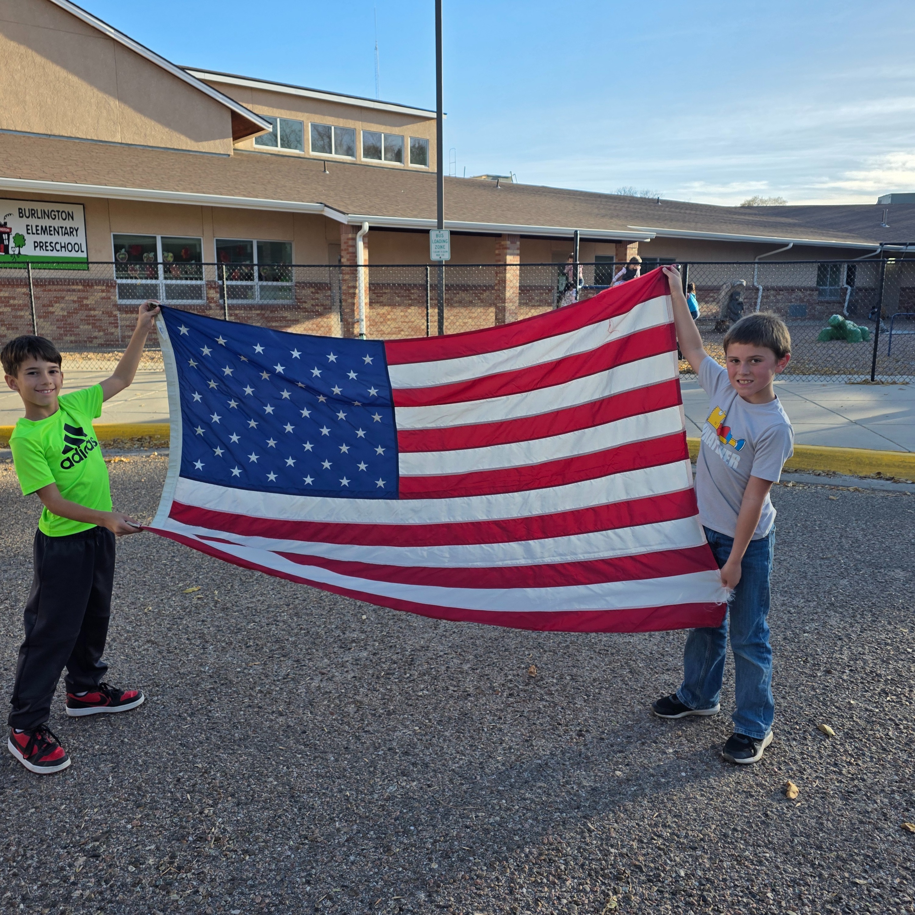 Kids taking down the american flag. 