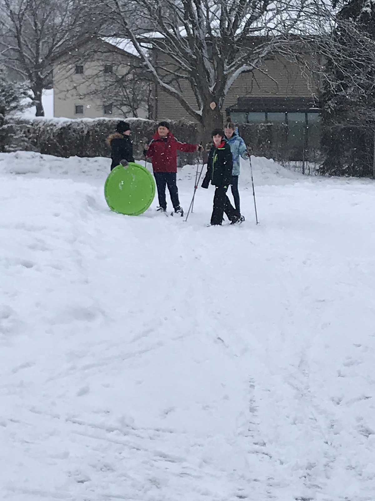A group of people standing in the snow.