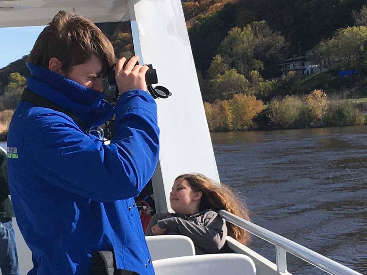 A man taking a picture of a woman on a boat.