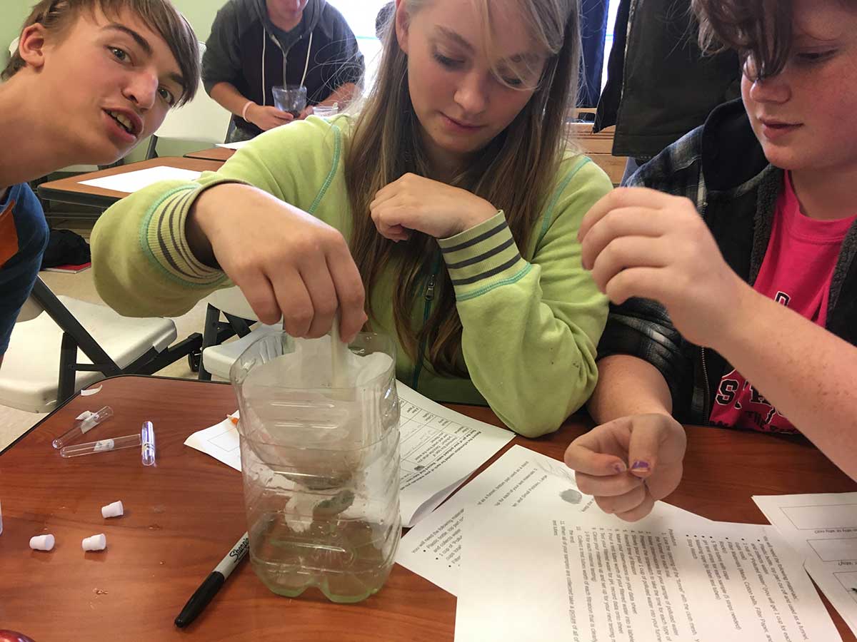 Three young people collaborating on a project.