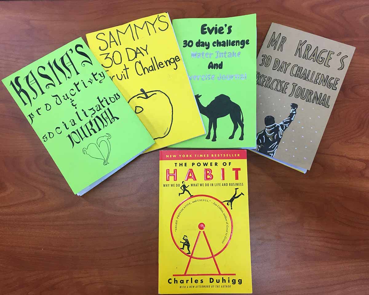 A stack of four books on a table.