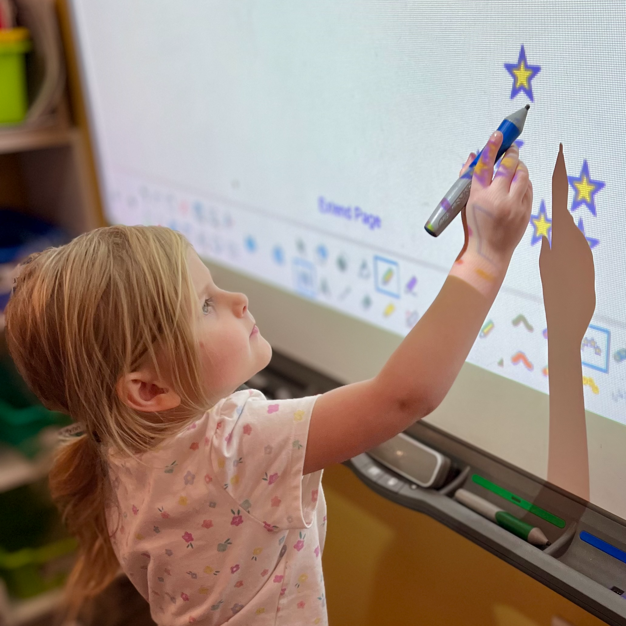 Young student working on smart board .