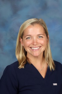 Female healthcare worker in blue scrubs.