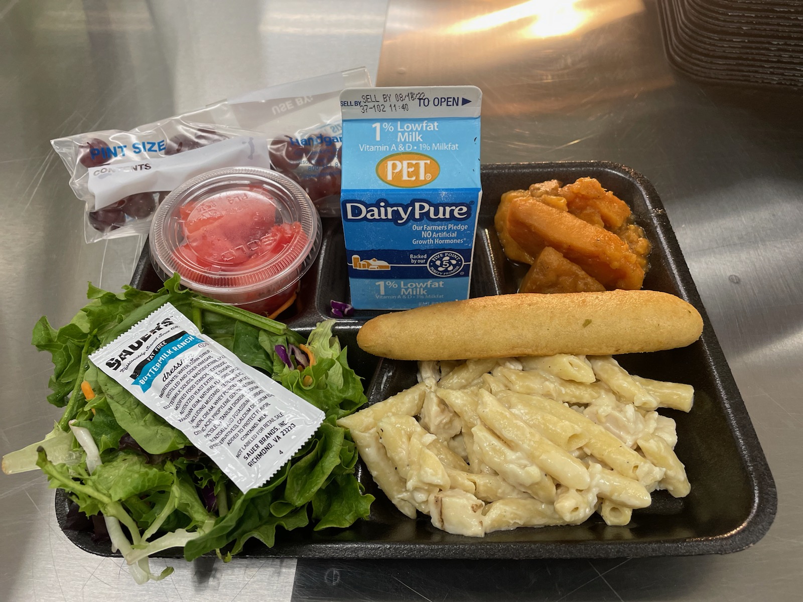 A metal tray topped with different types of food