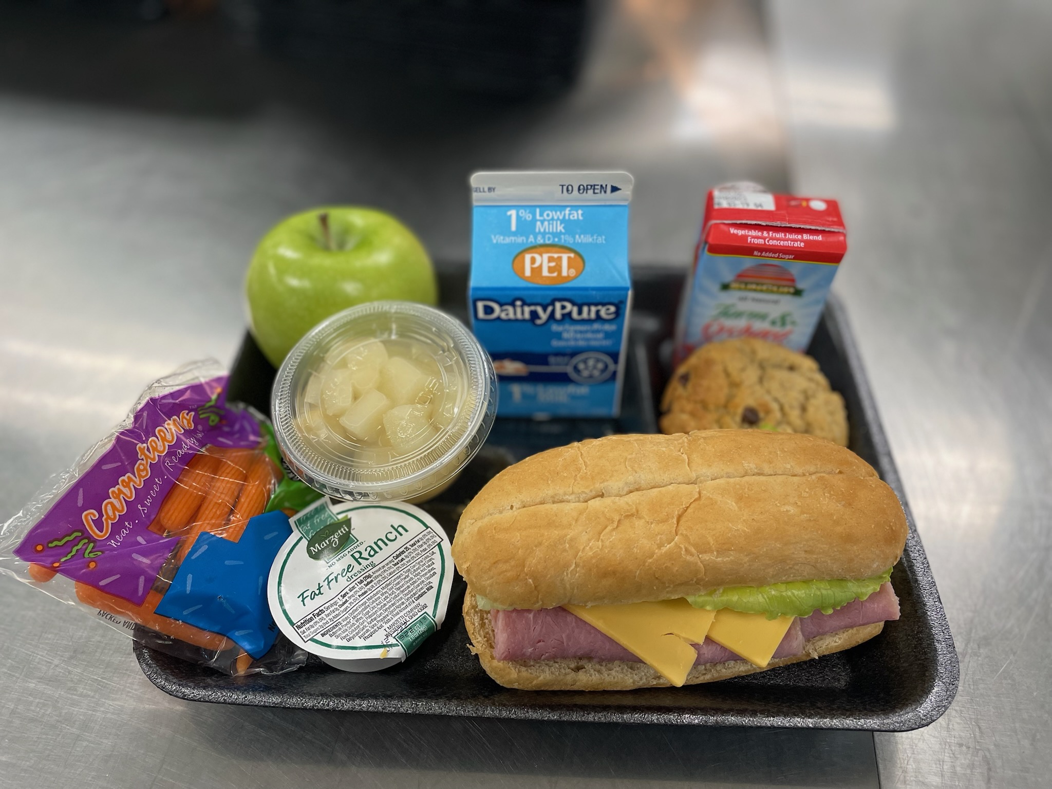 A metal tray topped with different types of food