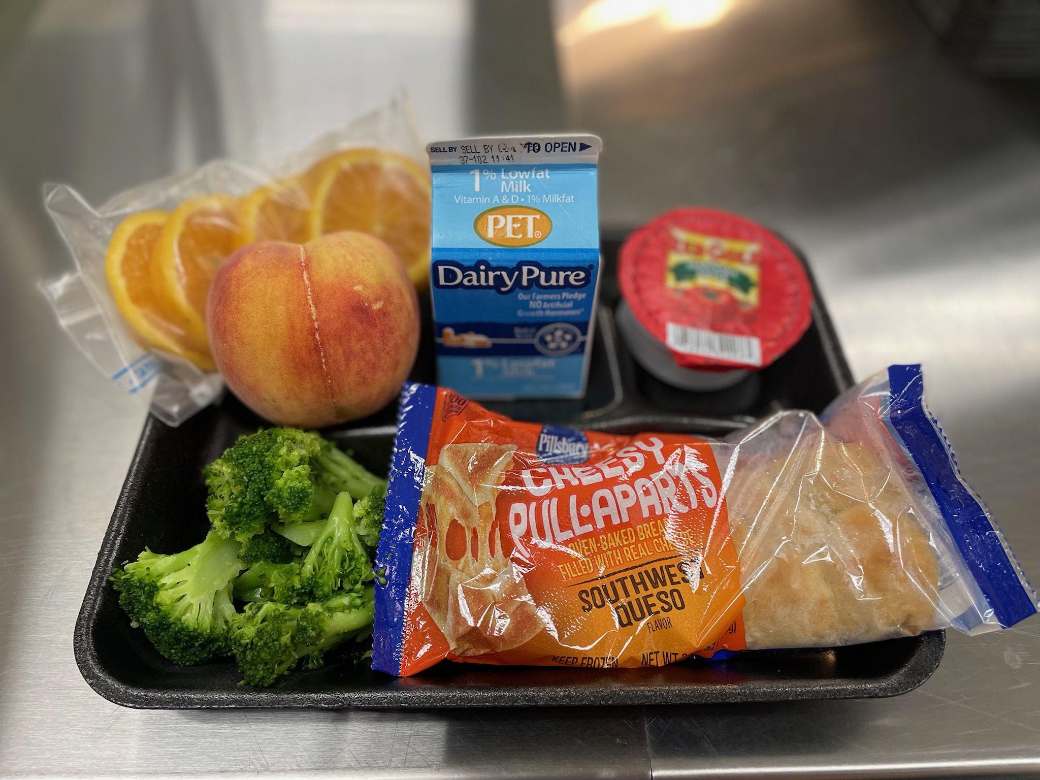 A metal tray topped with different types of food