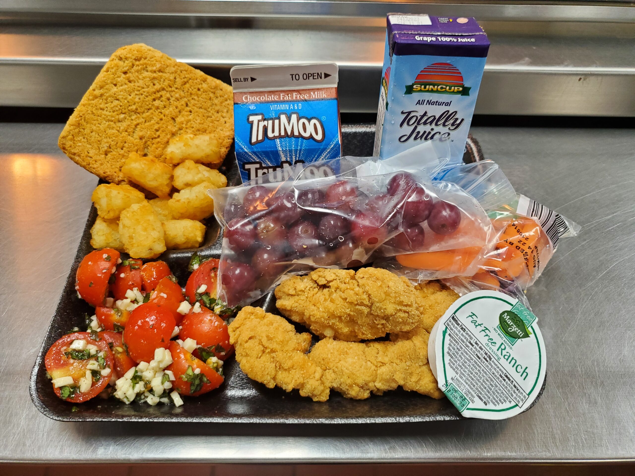 A metal tray topped with different types of food