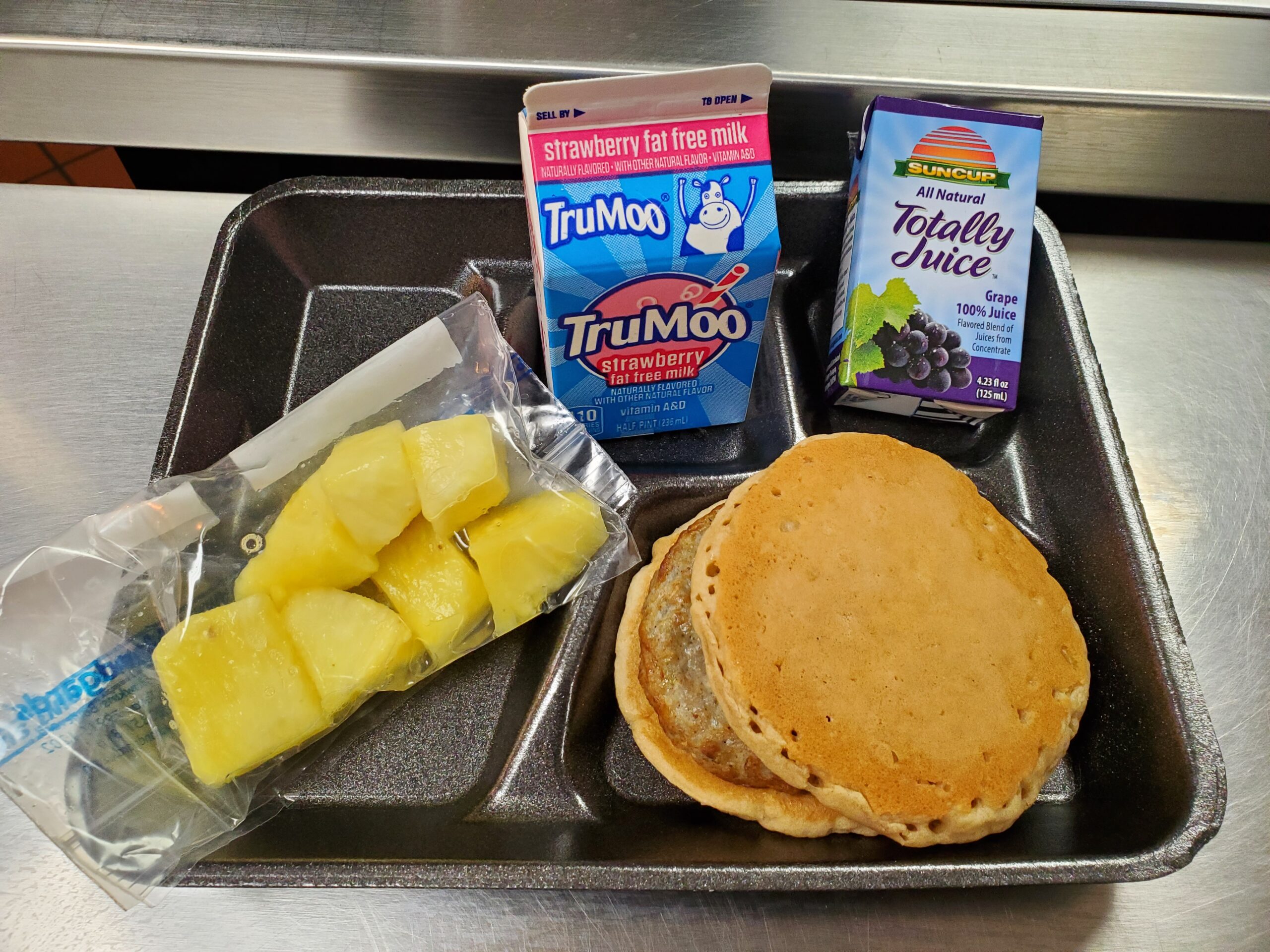 A metal tray topped with different types of food