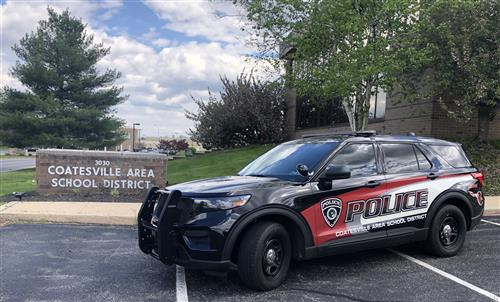 A police car parked in front of Coatesville Area School District