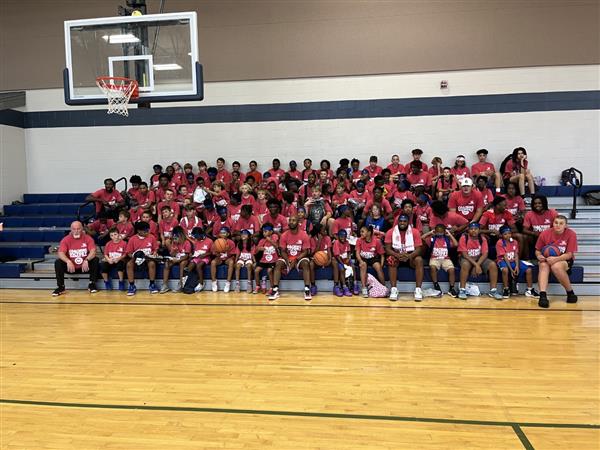 A group of people in red shirts on a basketball court