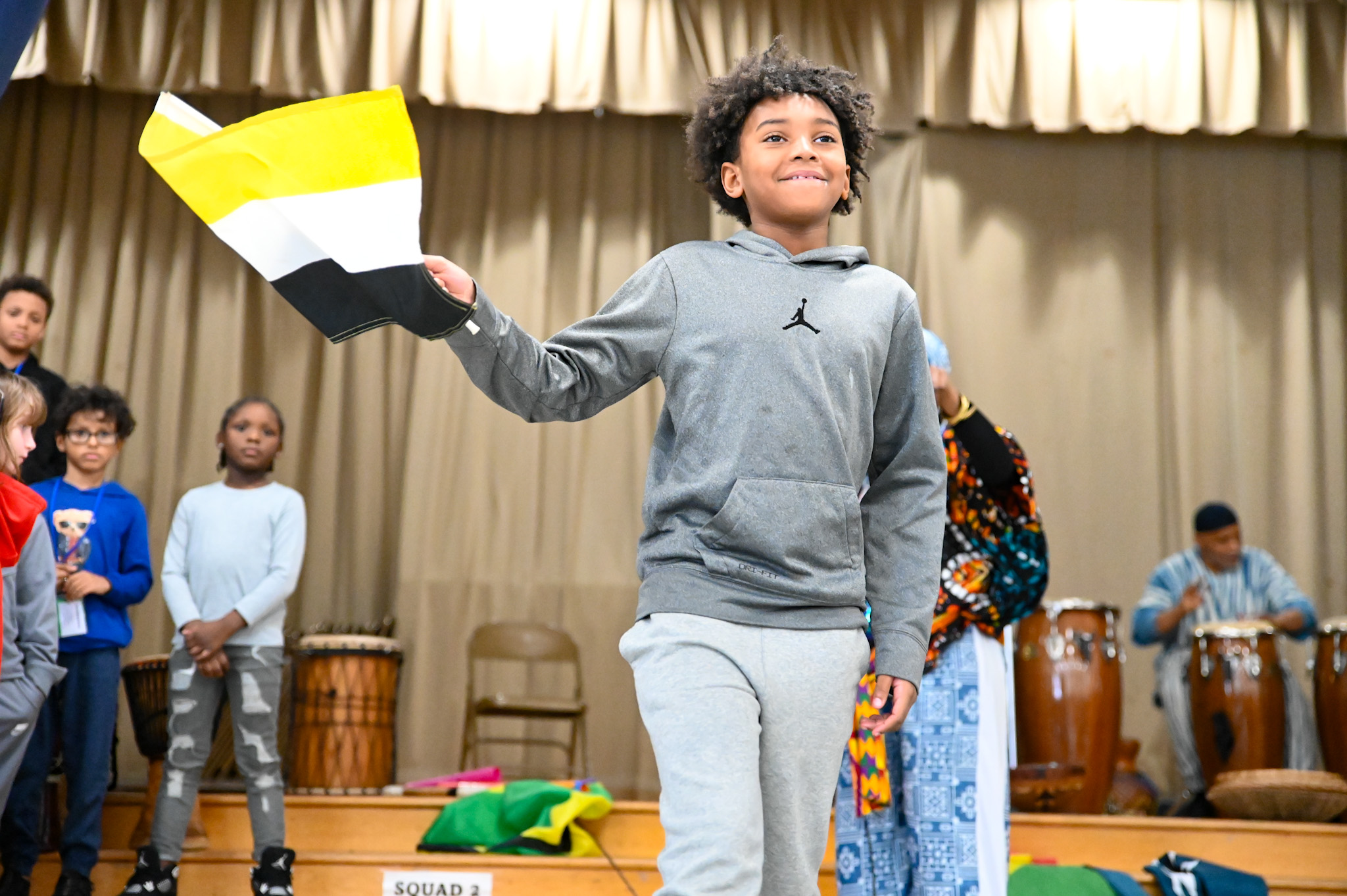 elementary student waiving flag