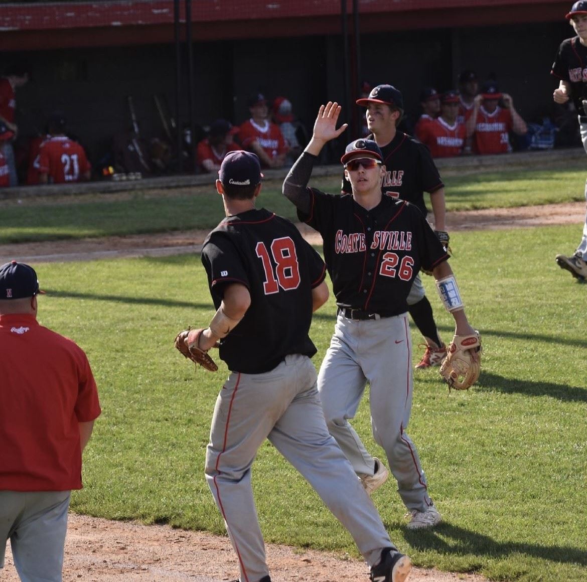 baseball player high fives team mate