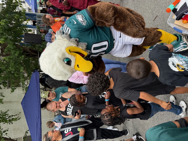 eagles mascot at the block party with some kids