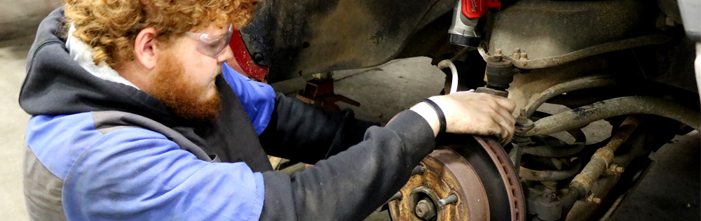 automotive banner photo of student working on a car